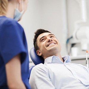 Palm Coast patient smiling at dentist talking about dental implants