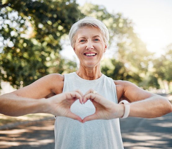 Lady makes shape of heart with her hands