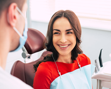 Woman smiling at dentist during exam