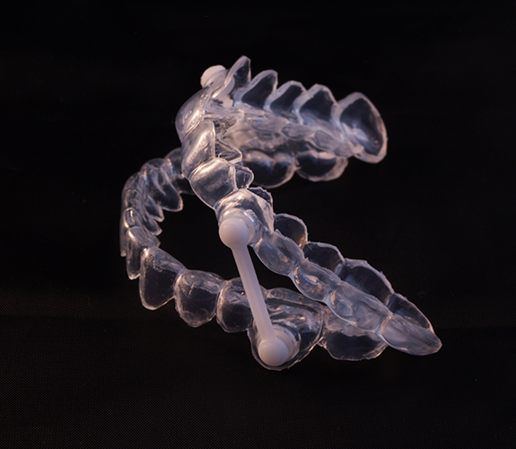Close-up of oral appliance on black background