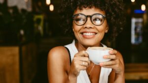 Woman with veneers drinking coffee
